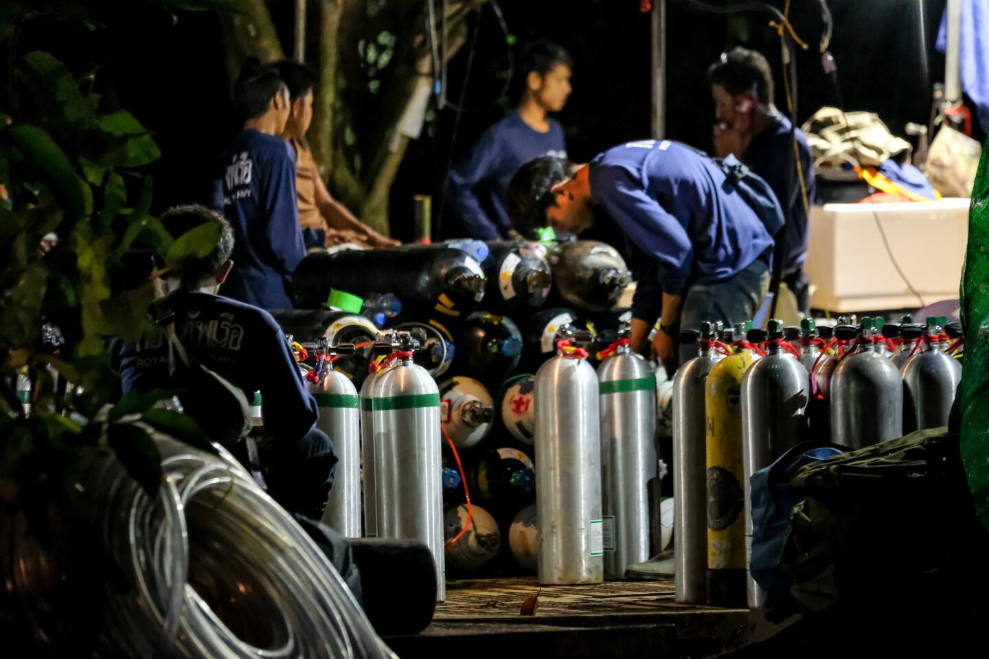 Diving cylinders are prepared at a makeshift camp at the entrance of Tham Luang Nang Non caves.