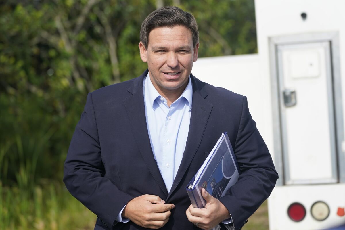 FILE - In this Tuesday, Aug. 3, 2021, file photo, Florida Gov. Ron DeSantis arrives at a news conference, near the Shark Valley Visitor Center in Miami. On Sunday, Sept. 12, three Republican presidential prospects, including DeSantis, sharply condemned President Joe Biden’s handling of the end of the war in Afghanistan, rebuking the administration’s conduct of the U.S. withdrawal as weak and as emboldening its adversaries. (AP Photo/Wilfredo Lee, File)