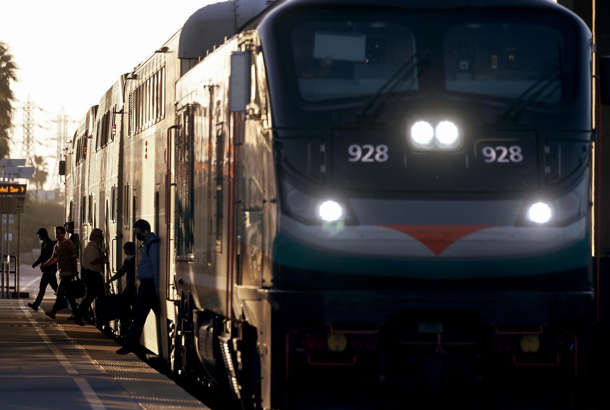 Passengers get off a Metrolink train in Anaheim.