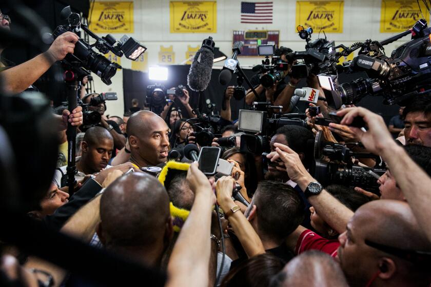 EL SEGUNDO, CALIF. -- MONDAY, SEPTEMBER 28, 2015: Lakers player Kobe Bryant fields questions from reporters surrounding him during Lakers Media Day in El Segundo, Calif., on Sept. 28, 2015. (Marcus Yam / Los Angeles Times)