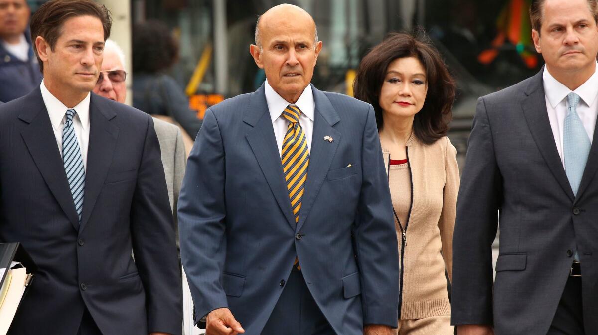 Former L.A. County Sheriff Lee Baca walks with his wife and attorneys to the U.S. Courthouse in downtown Los Angeles on May 12.