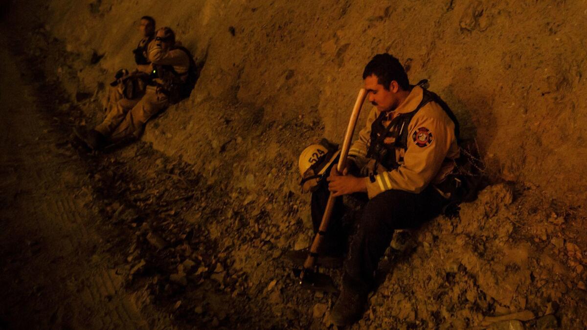 A firefighter takes a break during a burn operation near the town of Ladoga, Calif., last week.