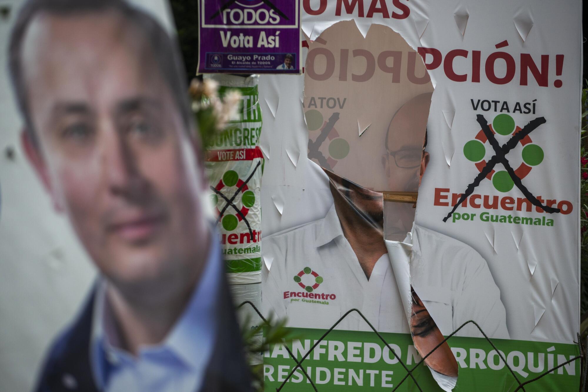 A campaign poster for Guatemalan presidential candidate Manfredo Marroquín is torn and tagged in black marker
