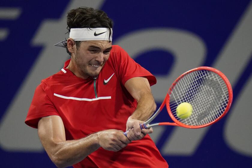 Taylor Fritz, of the United States, hits a return to Yoshihito Nishioka, of Japan.