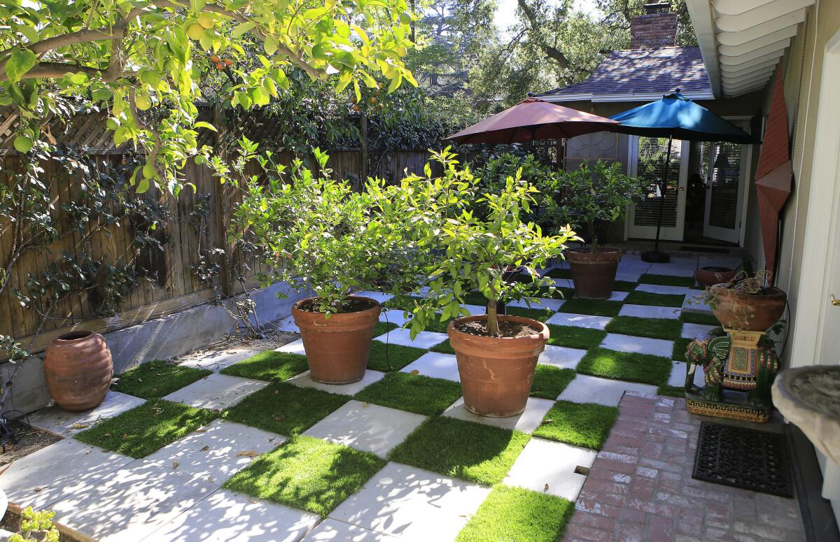 In Sierra Madre, artificial turf is mixed with concrete pavers for a checkerboard design that cuts water use.