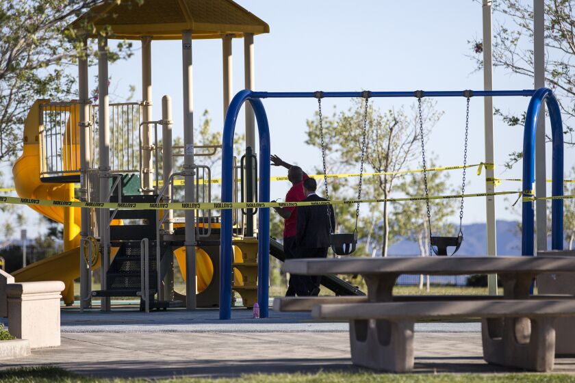 L.A. City Councilman Mitch Englander, right, inspects playground equipment with a park official after Holleigh Bernson Memorial Park was closed because an oily residue was found on the playground in Porter Ranch.