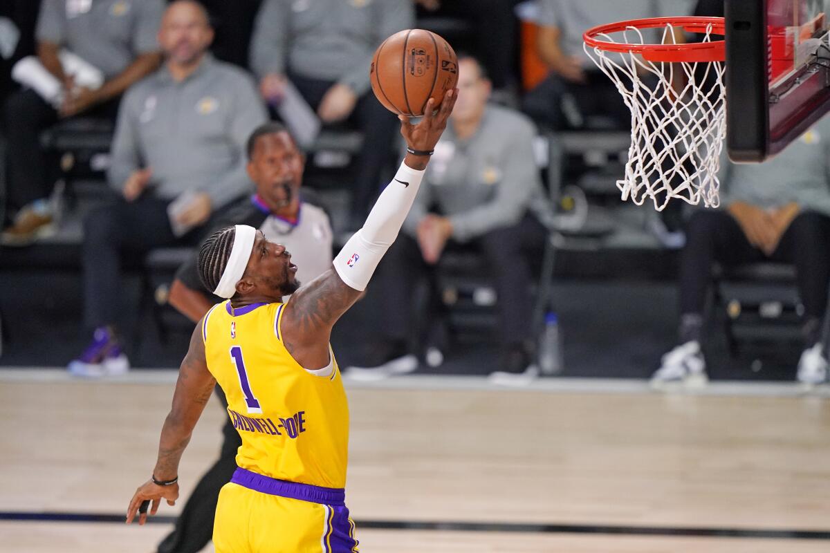 Lakers center Kentavious Caldwell-Pope scores against the Denver Nuggets during the first half of the Lakers' win.