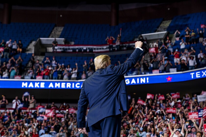 President Donald Trump arrives on stage to speak at Saturday's campaign rally at the BOK Center in Tulsa, Okla.