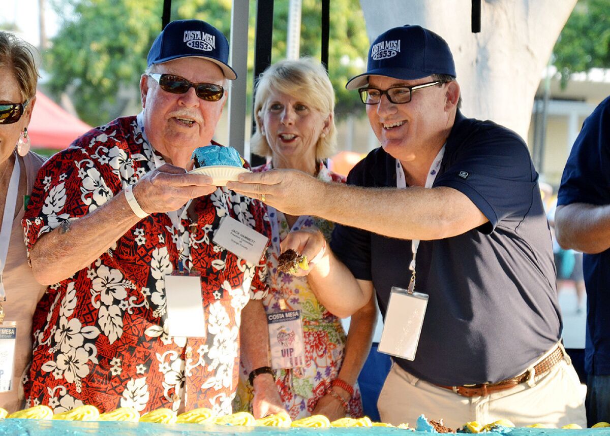 Jack Hammett, former Costa Mesa mayor and Pearl Harbor veteran, cuts cake with current Mayor Jim Righeimer at the city's 60th anniversary birthday celebration.