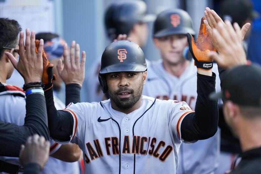 San Francisco Giants' LaMonte Wade Jr. celebrates in the dugout after hitting a home run during the fifth inning of a baseball game against the Los Angeles Dodgers in Los Angeles, Sunday, Sept. 24, 2023. Tyler Fitzgerald also scored. (AP Photo/Ashley Landis)