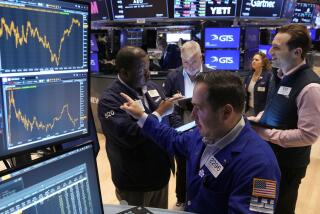 Specialist Genaro Saporito, foreground, works with traders at his post on the floor of the New York Stock Exchange, Wednesday, Sept. 18, 2024. (AP Photo/Richard Drew)