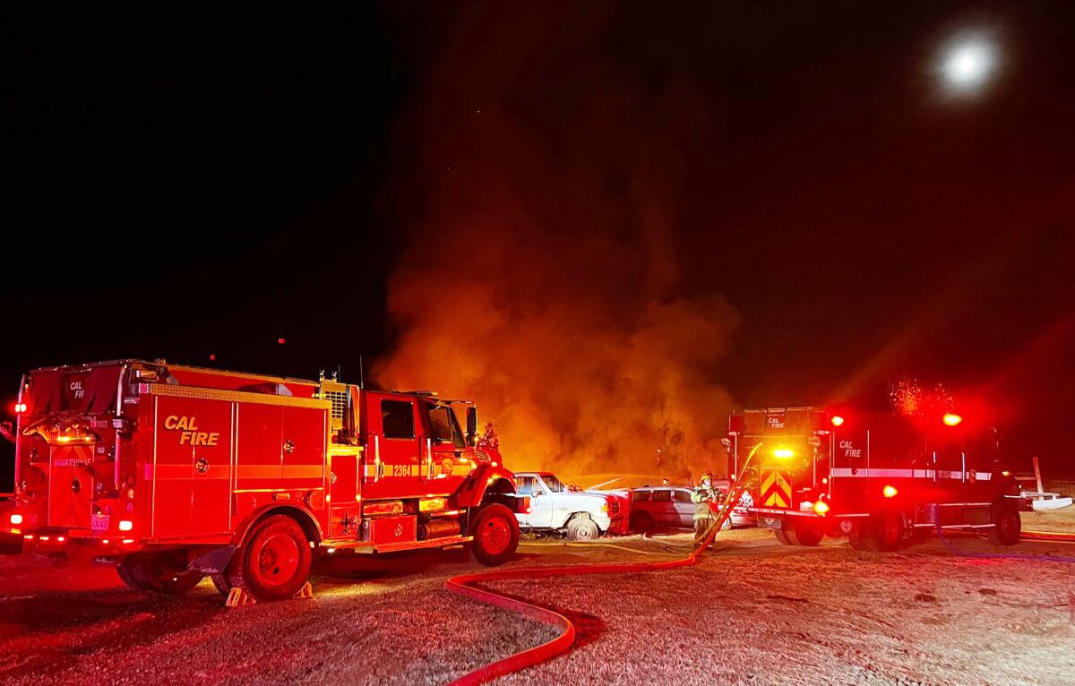 Fire trucks respond to a residential structure fire as smoke filled the night sky.