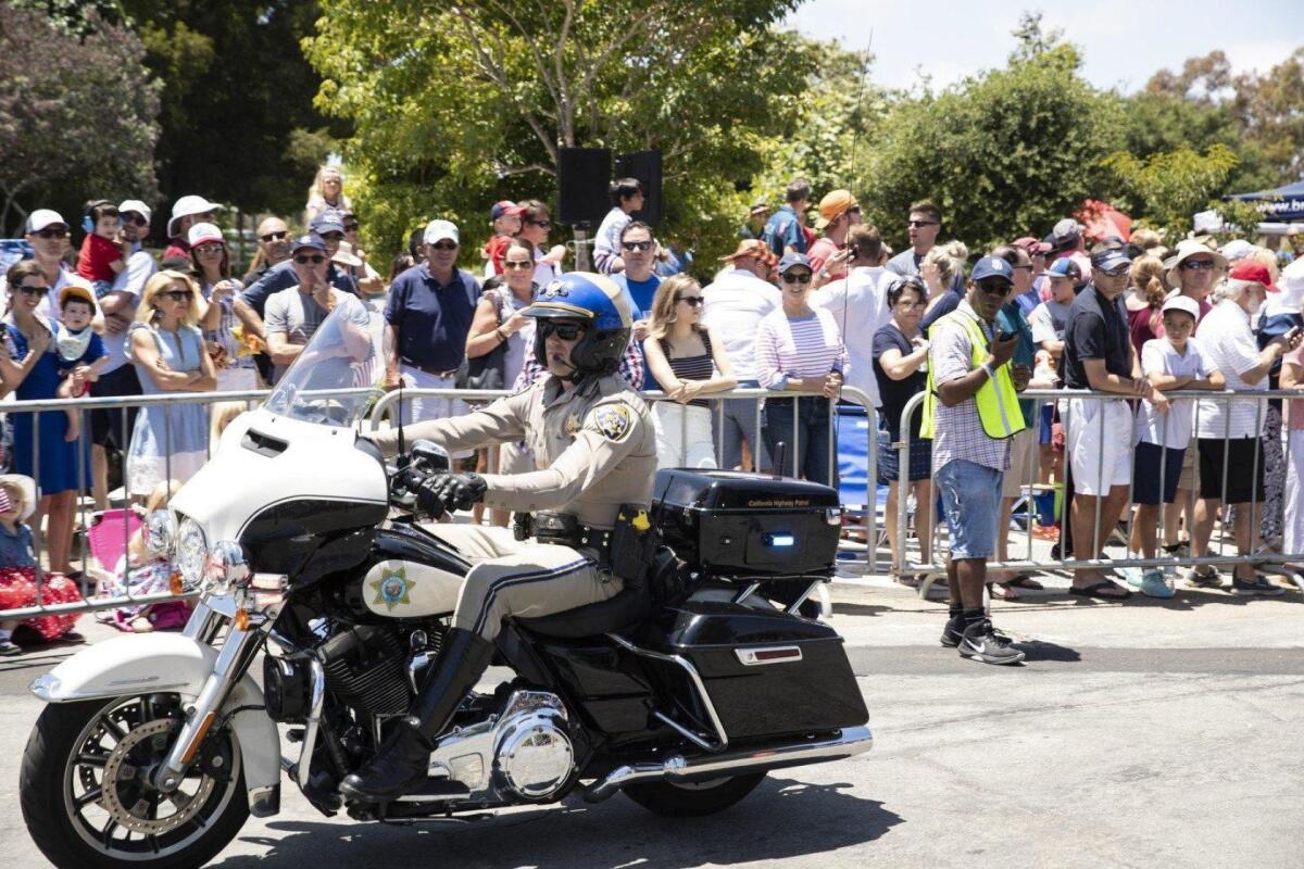 A CHP officer leads the way in this year's Fourth of July parade.