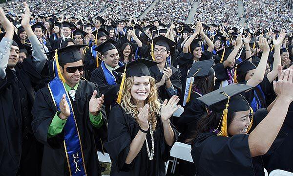 UCLA graduates clap and cheer after receiving their bachelor's degrees during commencement ceremonies.
