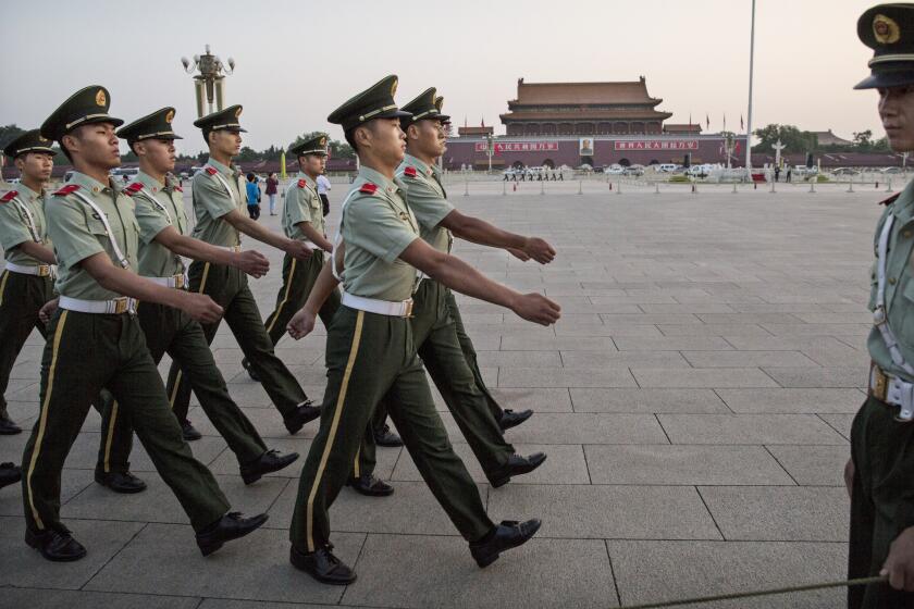 Chinese paramilitary soldiers march in Tiananmen Square in Beijing on Tuesday.