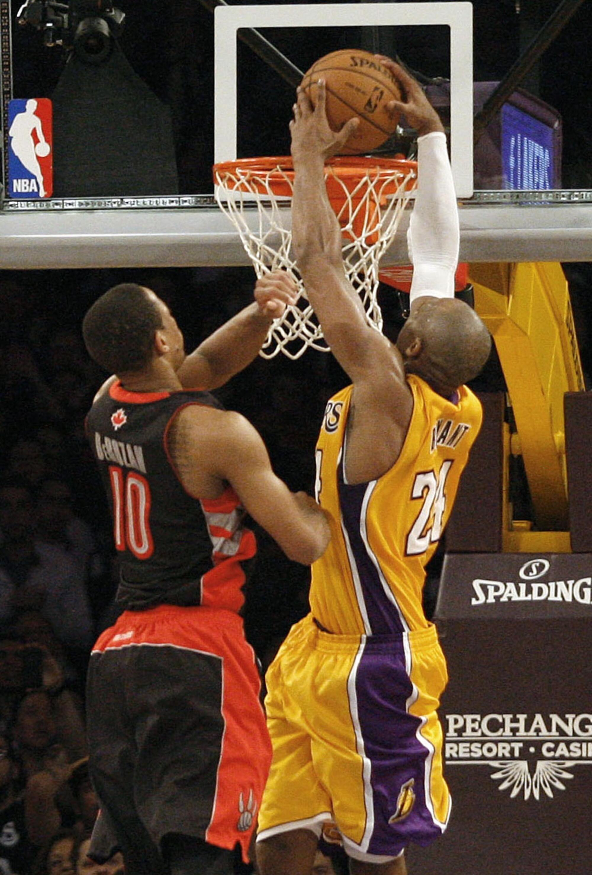 Lakers guard Kobe Bryant finishes goes up for a dunk against Raptors guard DeMar DeRozan.