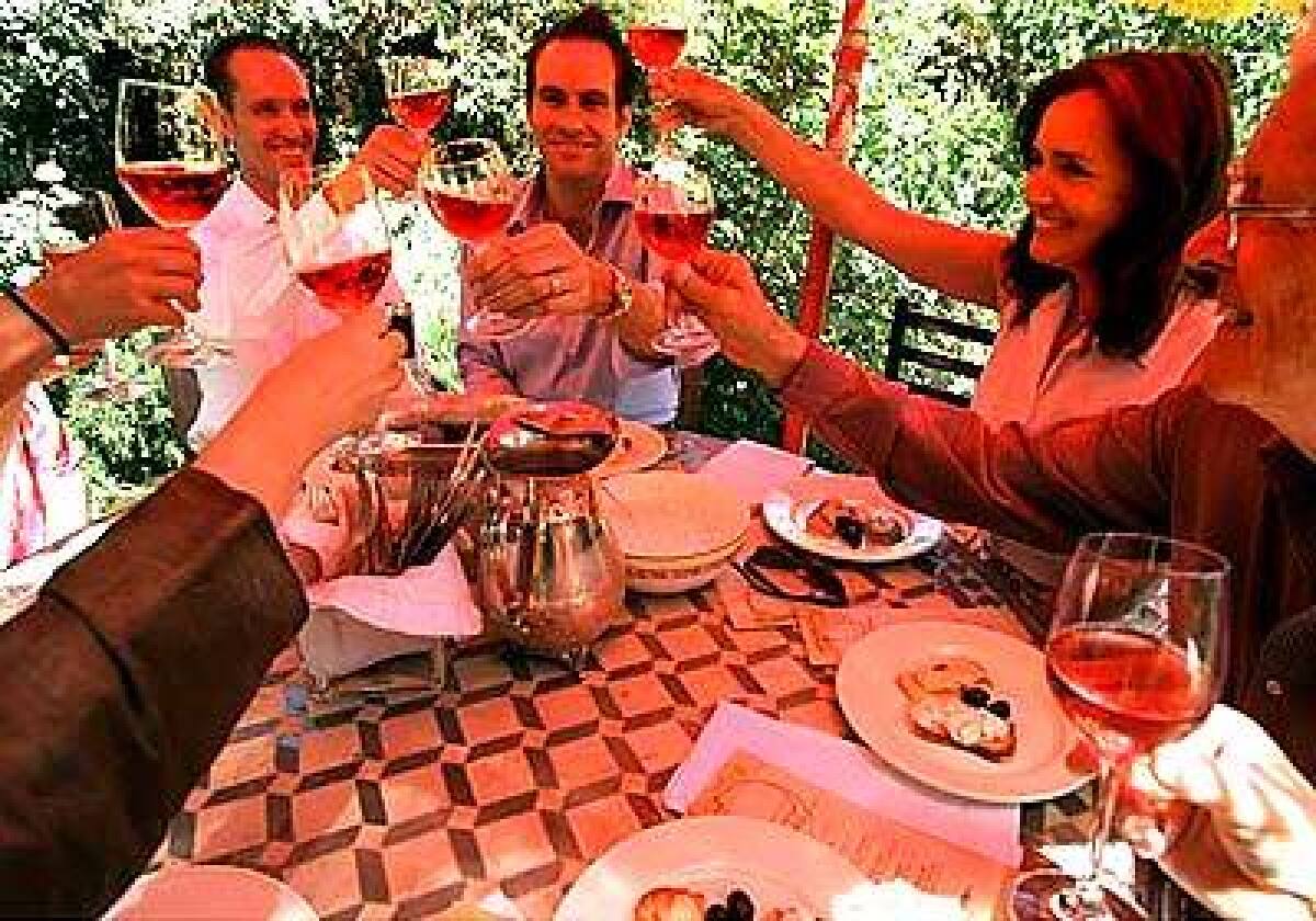 Erik Rieder, left, and David Herzog are surrounded by friends at a lunch in their honor. From a salud to Greek dips and steak tartare, every course contained toast.