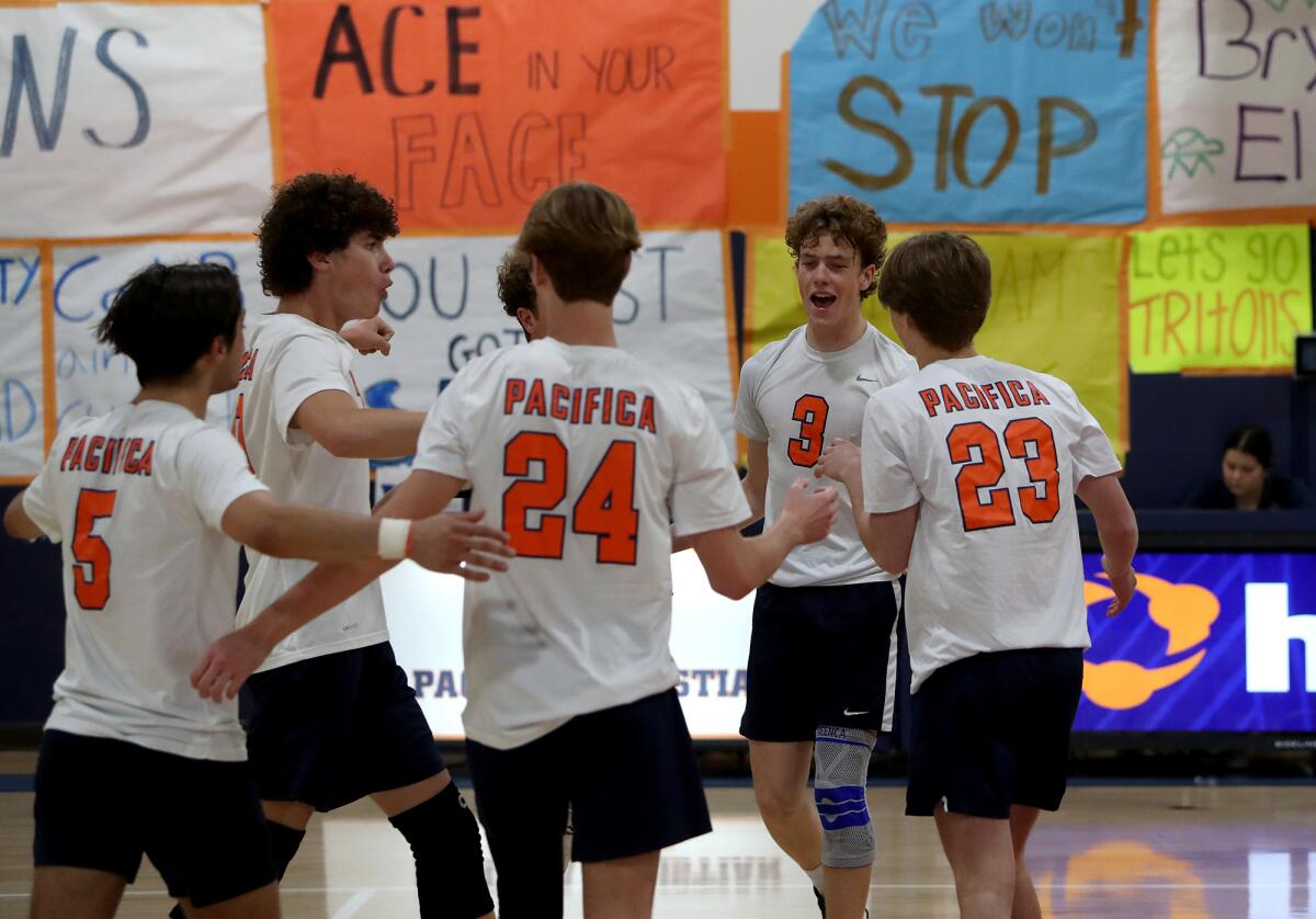 Pacifica Christian Orange County boys' volleyball players celebrate a point against Xavier Prep on Saturday.