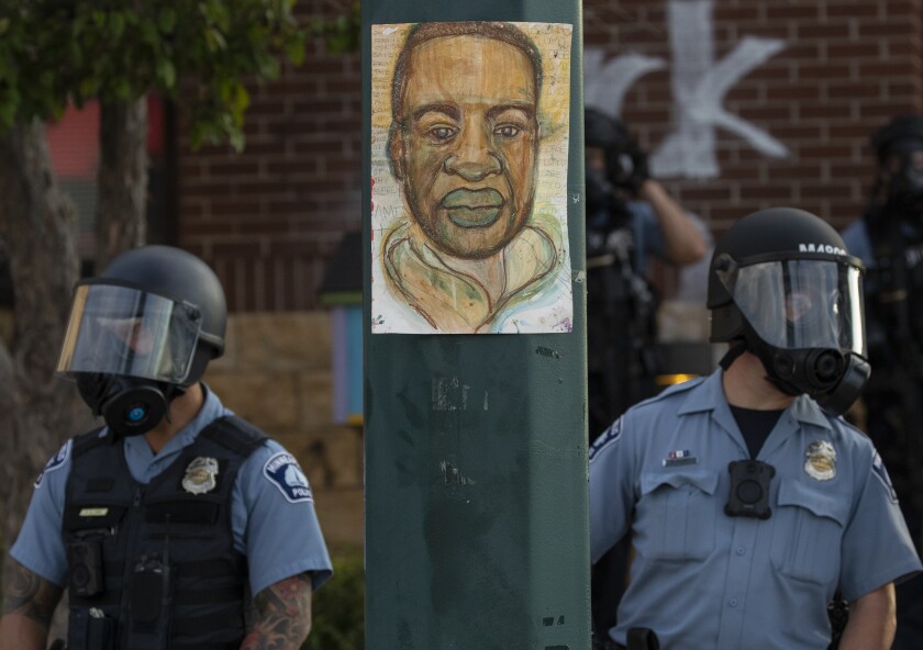 Minneapolis police stand near a drawing a George Floyd