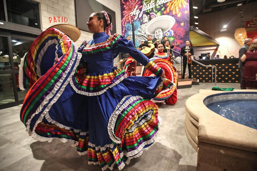 Dancers perform traditional Mexican dance during the grand opening of the Mercado Gonzalez, Northgate Market in Costa Mesa on Tuesday.