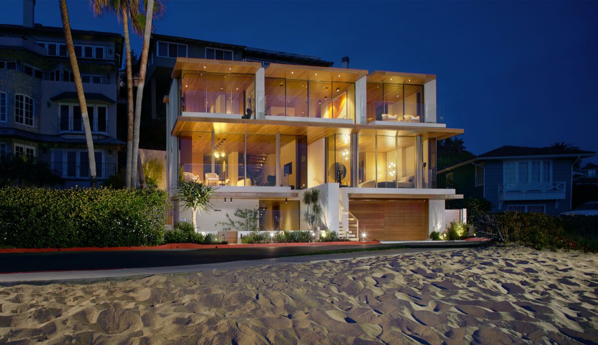 A glassy house by the sand.