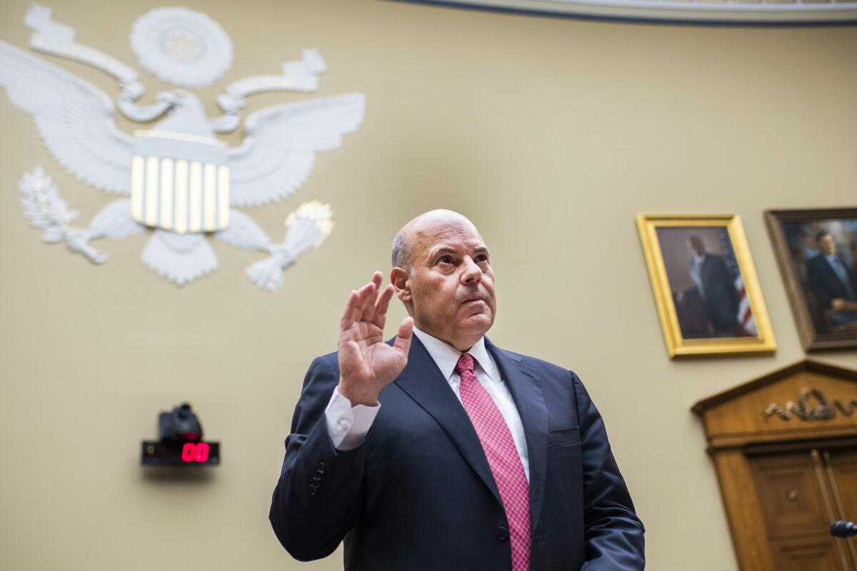 U.S. Postmaster General Louis DeJoy is sworn in to testify before a congressional committee.
