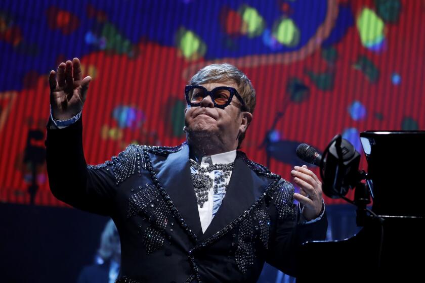 LOS ANGELES, CALIF. - JAN 22, 2019. Rock legend Elton John acknolwdges the applause from a sold-out crowd during the first of several farewell performances at Staples Center in Los Angeles on Tuesday night, Jan. 22, 2018. (Luis Sinco/Los Angeles Times)