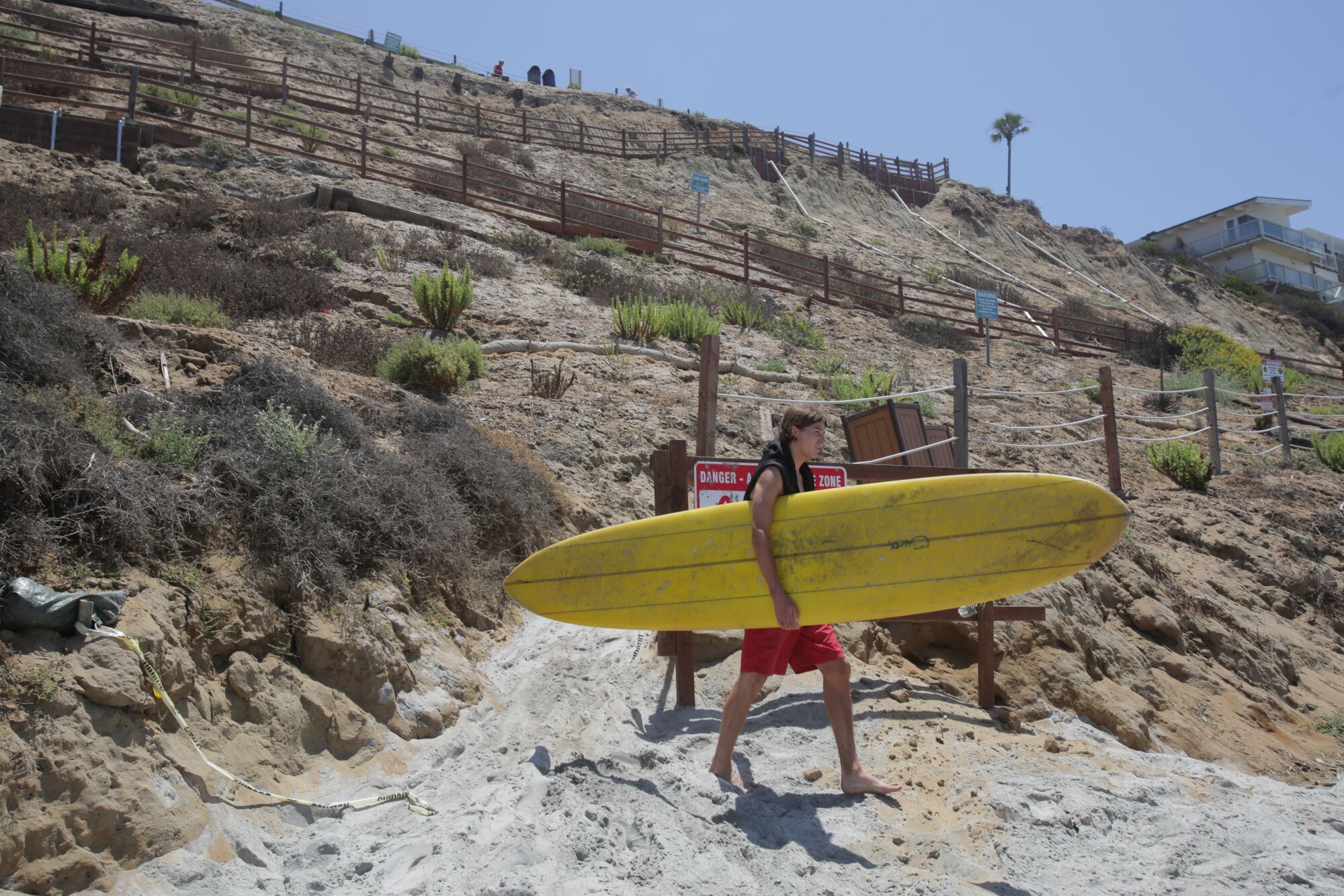 Kyle Roy, 19, reaches the base of the stairs at Beacon's Beach in Encinitas, CA .