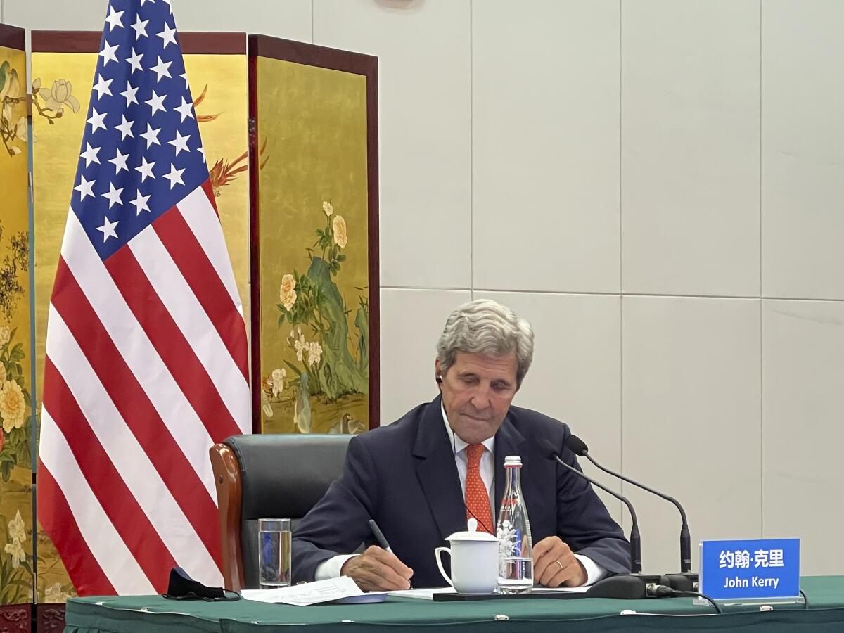 In this photo provided by the U.S. Department of State, U.S. Special Presidential Envoy for Climate John Kerry attends a meeting with Chinese Foreign Minister Wang Yi via video link in Tianjin, China, Wednesday, Sept. 1, 2021. Wang warned Kerry on Wednesday that deteriorating U.S.-China relations could undermine cooperation between the two on climate change. (U.S. Department of State via AP)