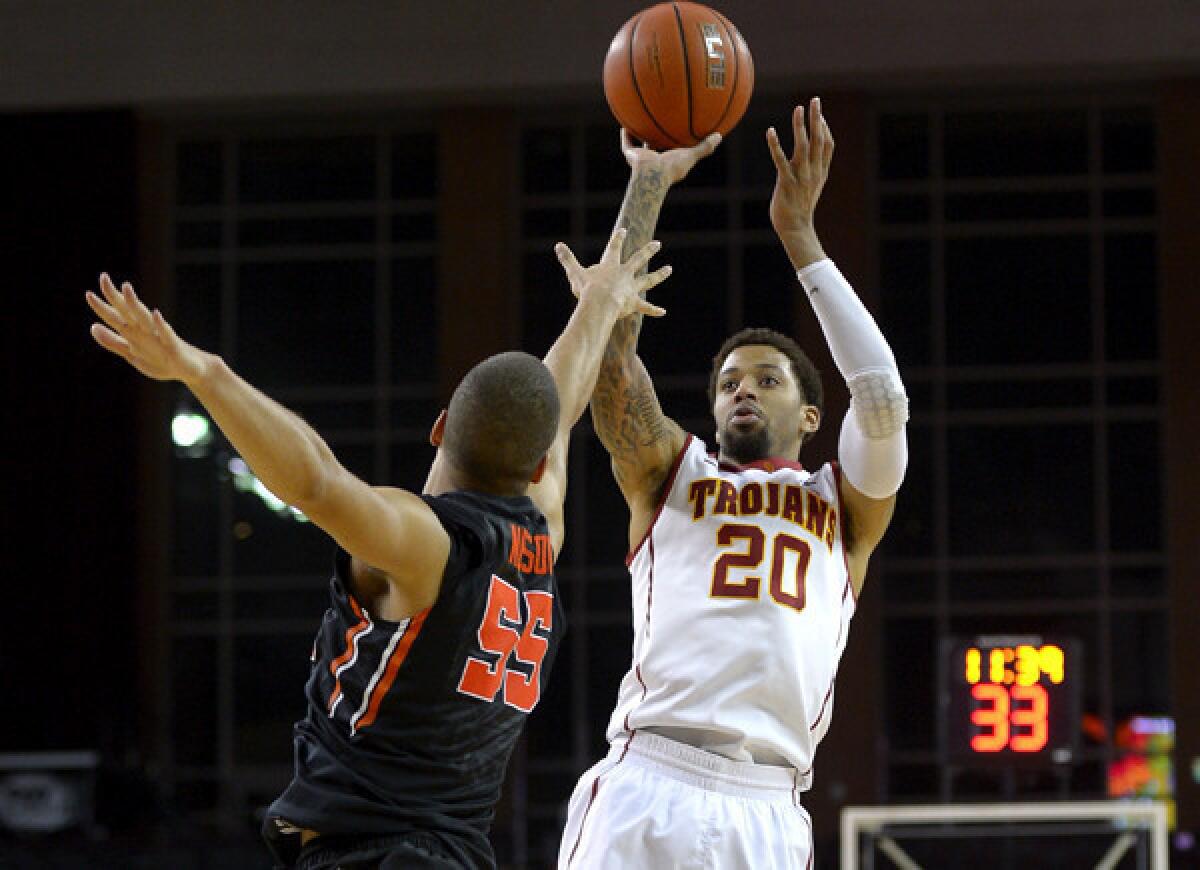 USC guard J.T. Terrell (20) pulls up for a jumper over Oregon State guard Roberto Nelson on Thursday night at Galen Center.