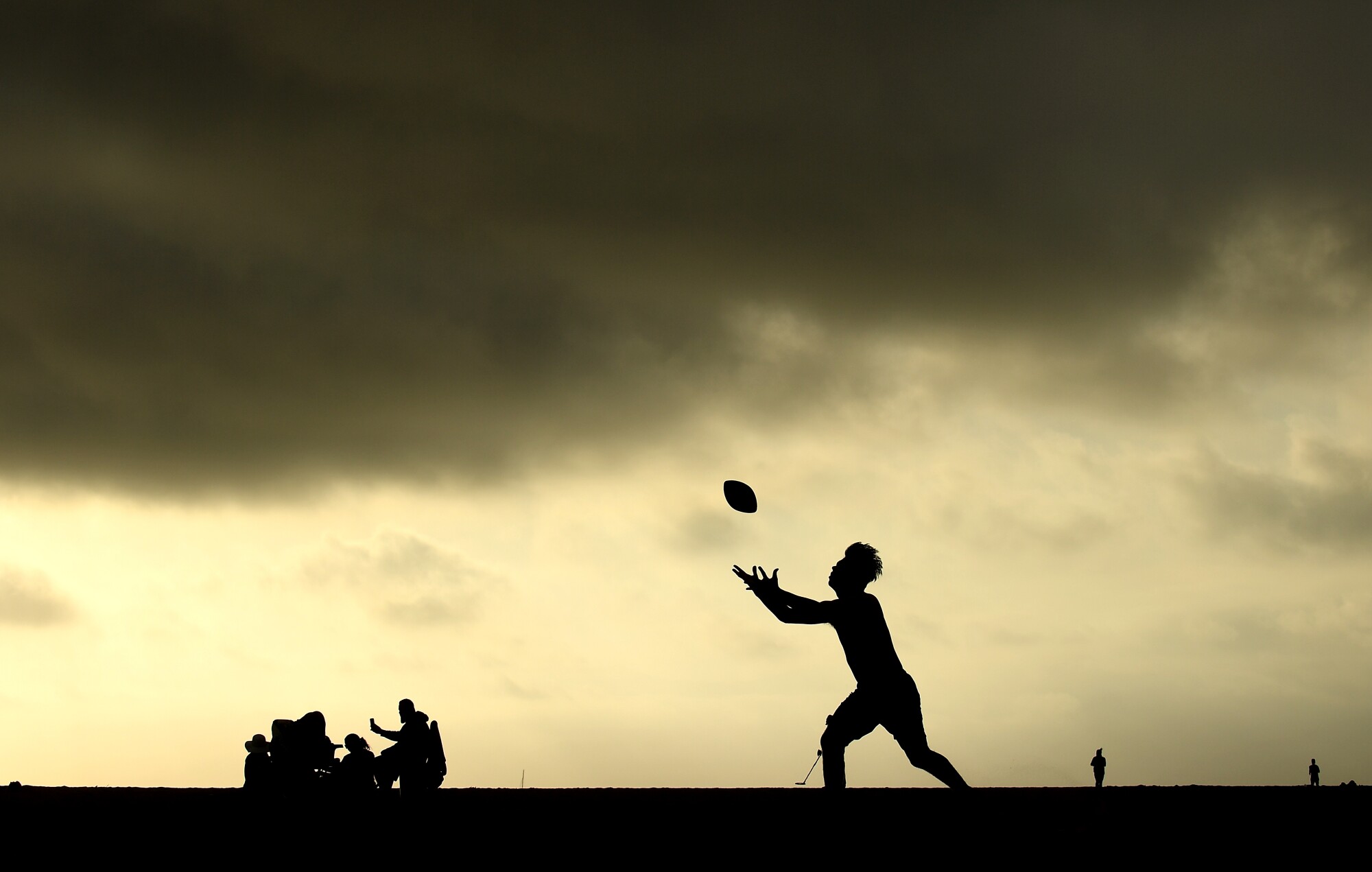 David Ruiz of Compton plays football a Venice Beach on Tuesday.