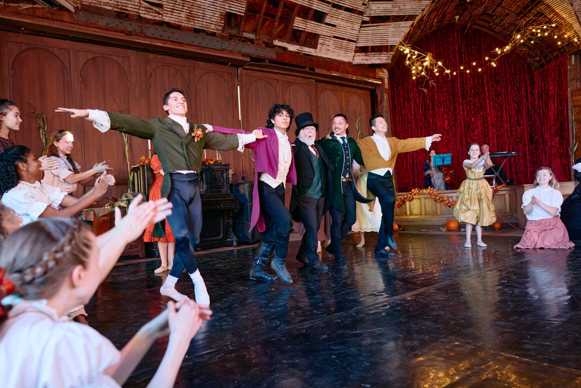 Four men of varying ages pose during a performance at the immersive 'Little Women Ballet'