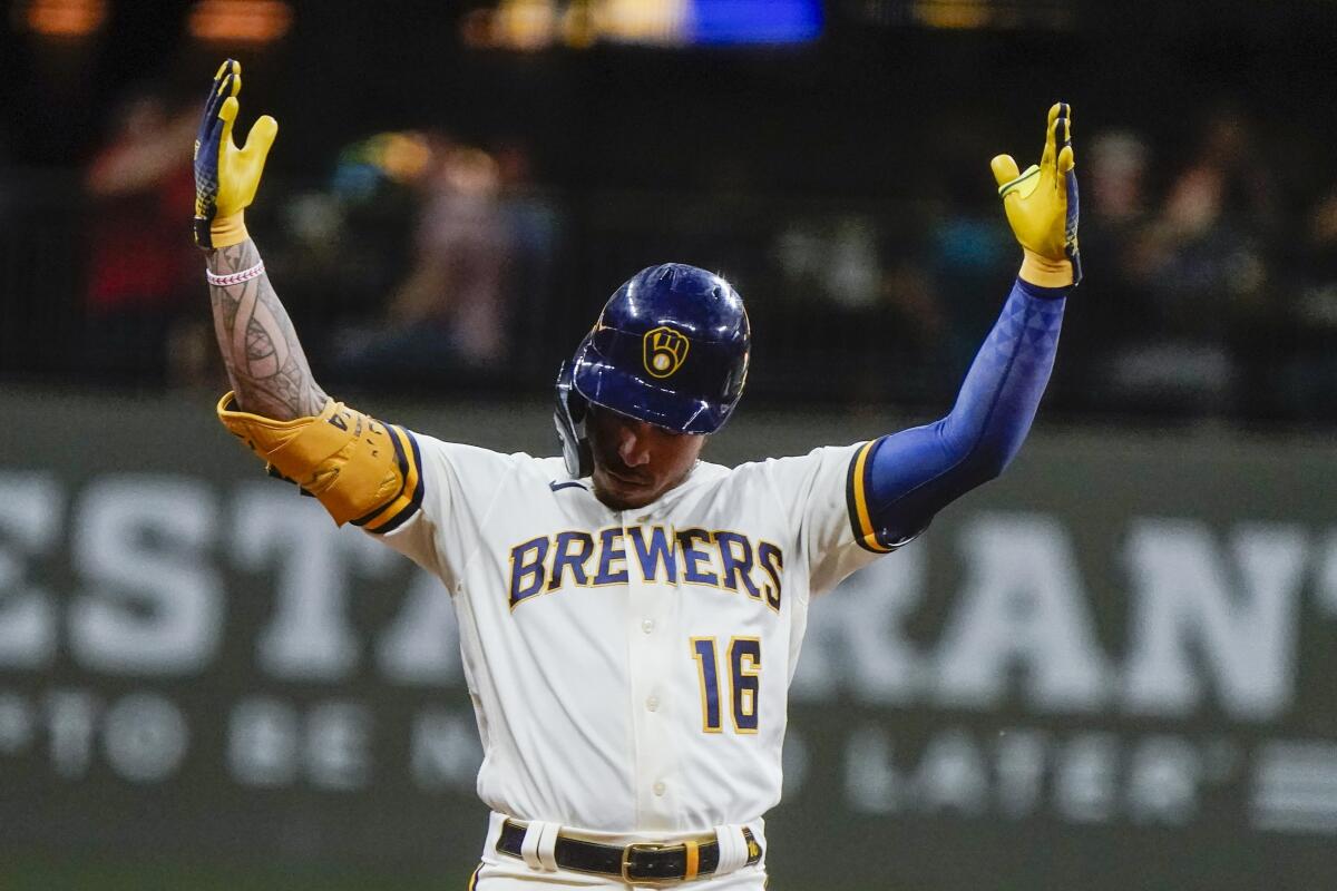 Milwaukee Brewers' Kolten Wong reacts after two runs scored on his hit during the fifth inning of a baseball game against the Tampa Bay Rays Tuesday, Aug. 9, 2022, in Milwaukee. (AP Photo/Morry Gash)