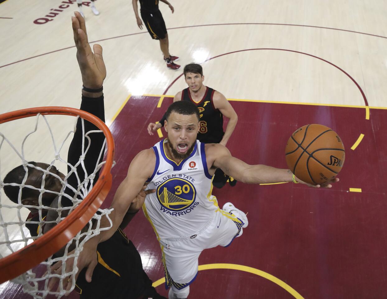 Golden State Warriors' Stephen Curry shoots against Cleveland Cavaliers' LeBron James during the second half of Game 4 of basketball's NBA Finals, Friday, June 8, 2018, in Cleveland. The Warriors defeated the Cavaliers 108-85. (Kyle Terada/Pool Photo via AP)