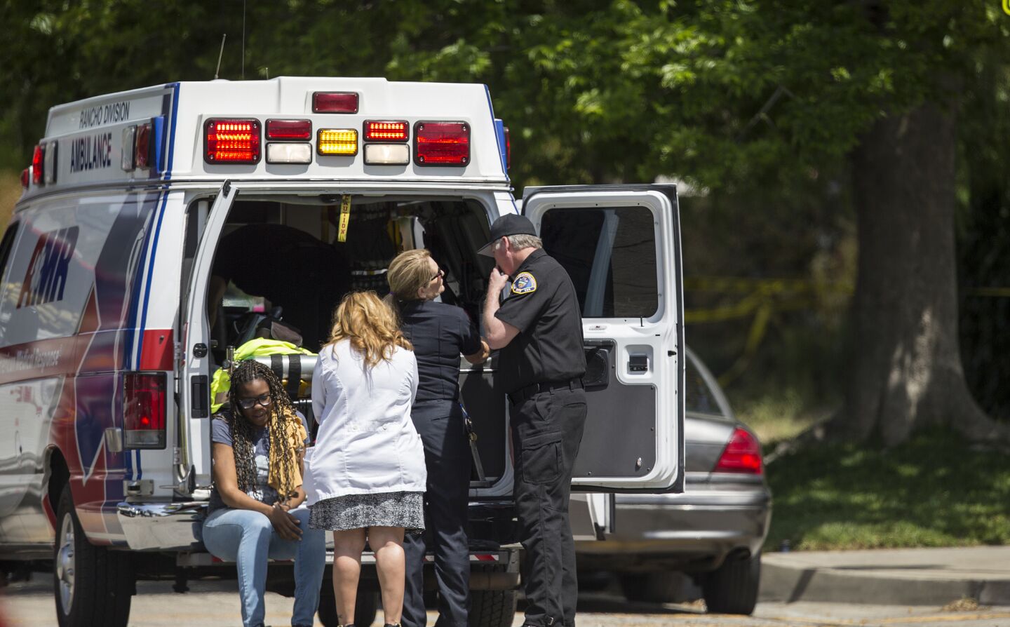 A woman is tended to outside North Park Elementary School.