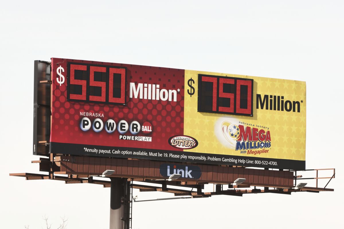 A billboard advertises the jackpots of the Powerball and Mega Millions lotteries, in Omaha, Neb., Wednesday, Jan. 13, 2021. Lottery players will have a shot Friday night at the fifth-largest jackpot in U.S. history after no tickets matched all the numbers in the latest Mega Millions drawing. The big prize for Powerball, the other national lottery game, is $550 million for Wednesday night's drawing. (AP Photo/Nati Harnik)