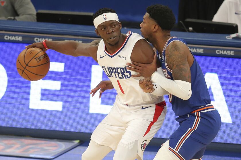 Los Angeles Clippers point guard Reggie Jackson (1) controls the ball against New York Knicks point guard Elfrid Payton (6) during the first half of an NBA basketball game Sunday, Jan. 31, 2021, in New York. (Brad Penner/Pool Photo via AP)