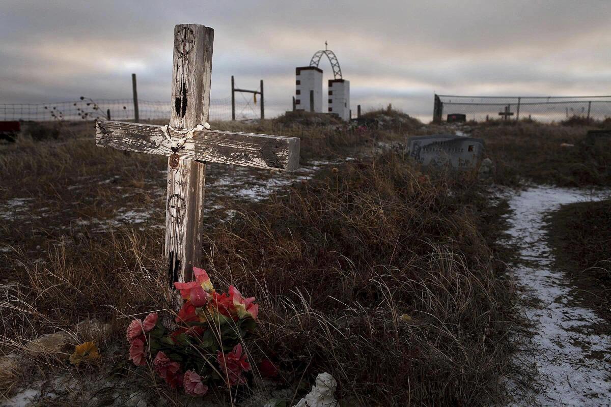 A cross next to flowers and grass