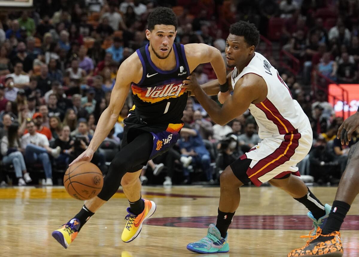 Devin Booker scores 23 in return, Suns roll past Heat to clinch playoff  spot
