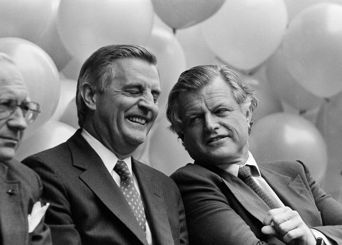 Former Vice President Walter Mondale laughs as he talks to Sen. Edward Kennedy
