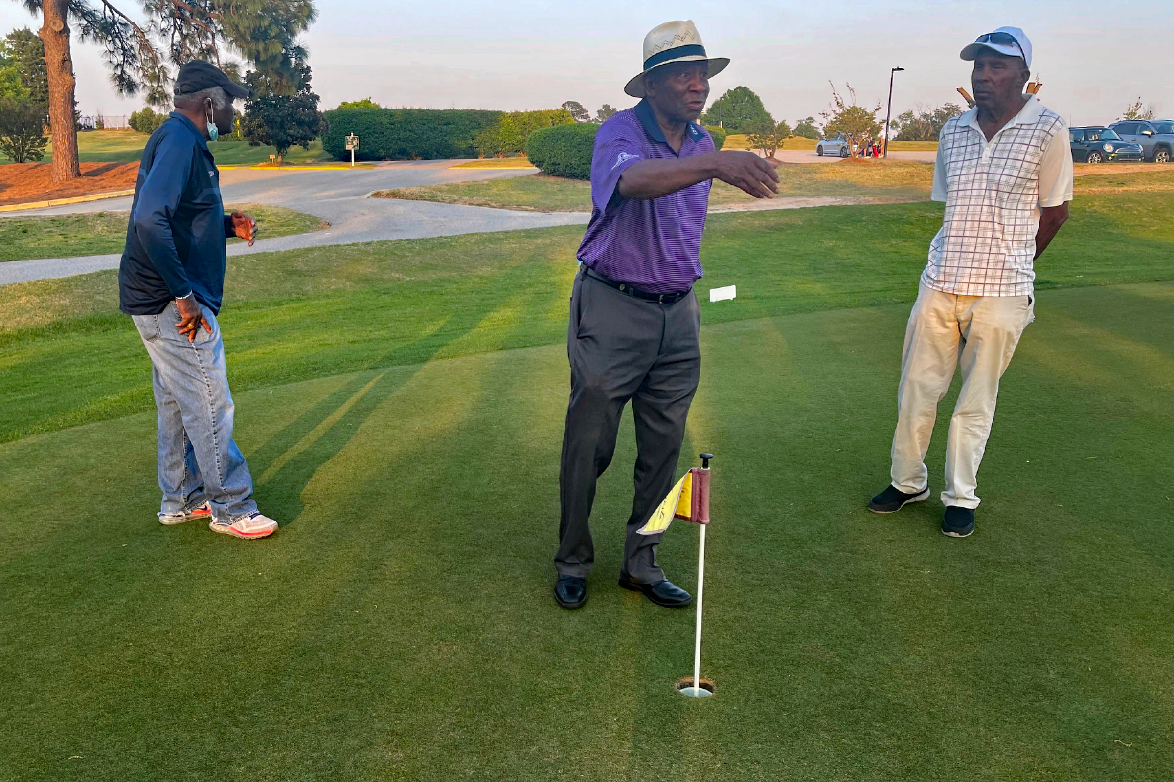 Caddies Tommy Bennett (in white), Buck Moore (dark blue), and Jariah Beard (purple)  at Augusta Municipal Golf Course.