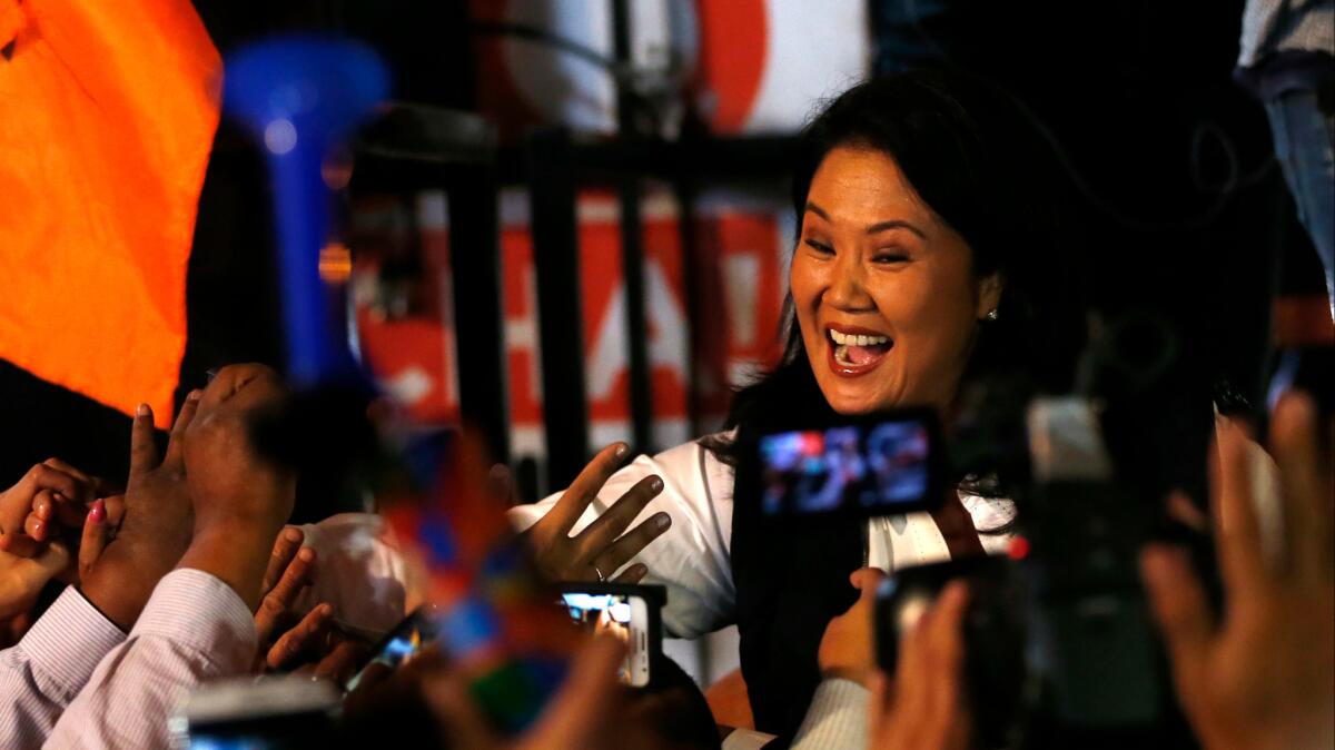 Peruvian presidential candidate Keiko Fujimori, the daughter of imprisoned ex-President Alberto Fujimori, greets supporters in Lima on June 5, 2016.