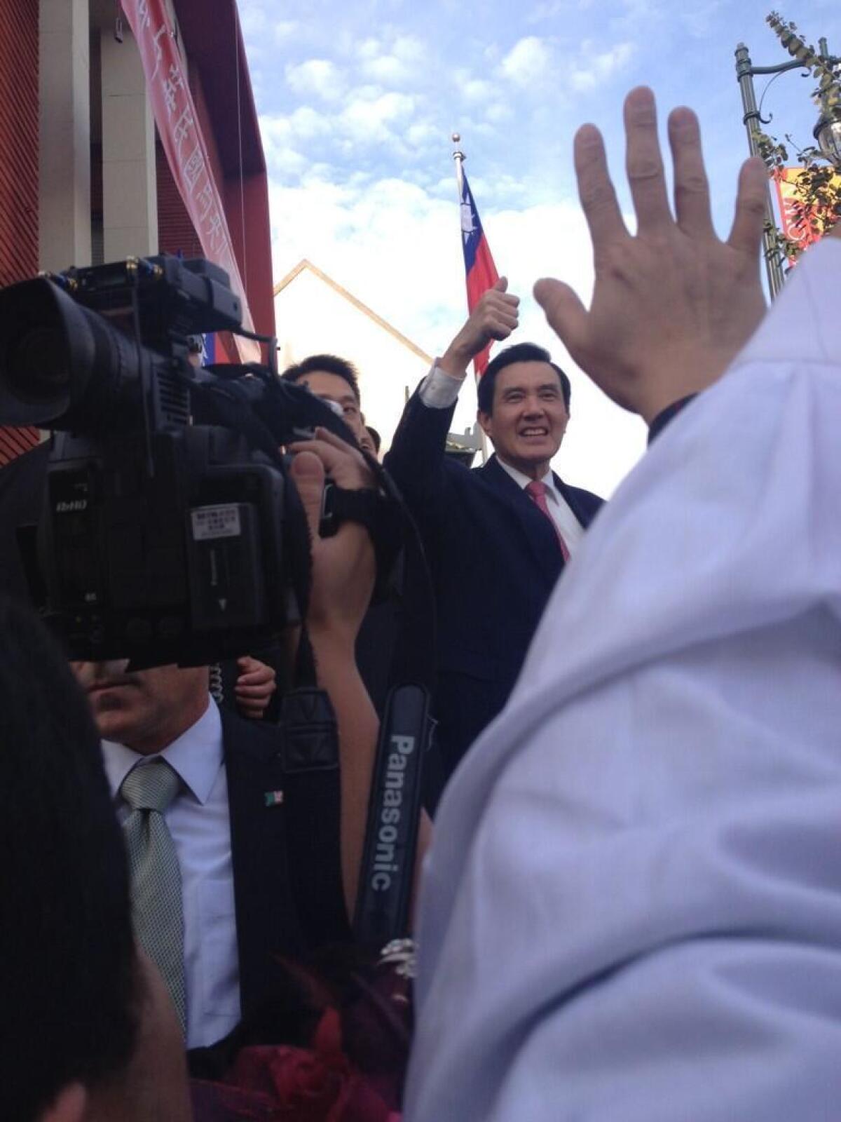 Taiwanese President Ma Ying-jeou gestures to supporters during a visit to Los Angeles' Chinatown on Tuesday afternoon.