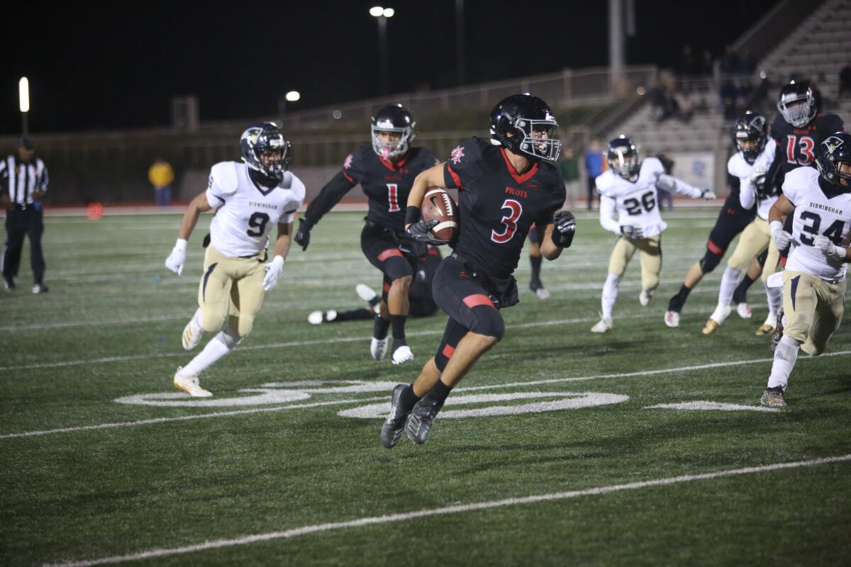 Wilmington Banning wide receiver Richard Cox carries the ball during a game against Van Nuys Birmingham.