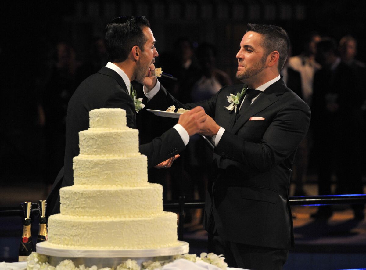 Proposition 8 plaintiffs Paul Katami and Jeff Zarrillo cut their wedding cake Saturday in a ceremony before friends and family at the Beverly Hilton.