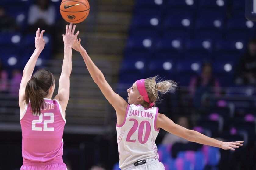 Penn State's Makenna Marisa (20) attempts to block a shot by Iowa's Caitlin Clark (22) during the first half of an NCAA college basketball game, Sunday, Feb. 5, 2023, in State College, Pa. (AP Photo/Gary M. Baranec)