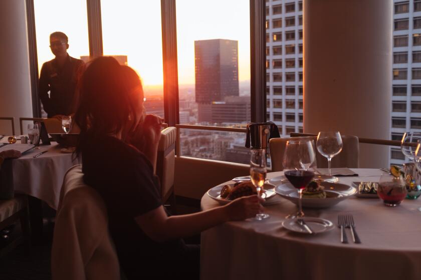 Los Angeles Times' Food Features Photo Editor Angeline Woo, at the top floor of the Westin Bonaventure Hotel in downtown Los Angeles during sunset.