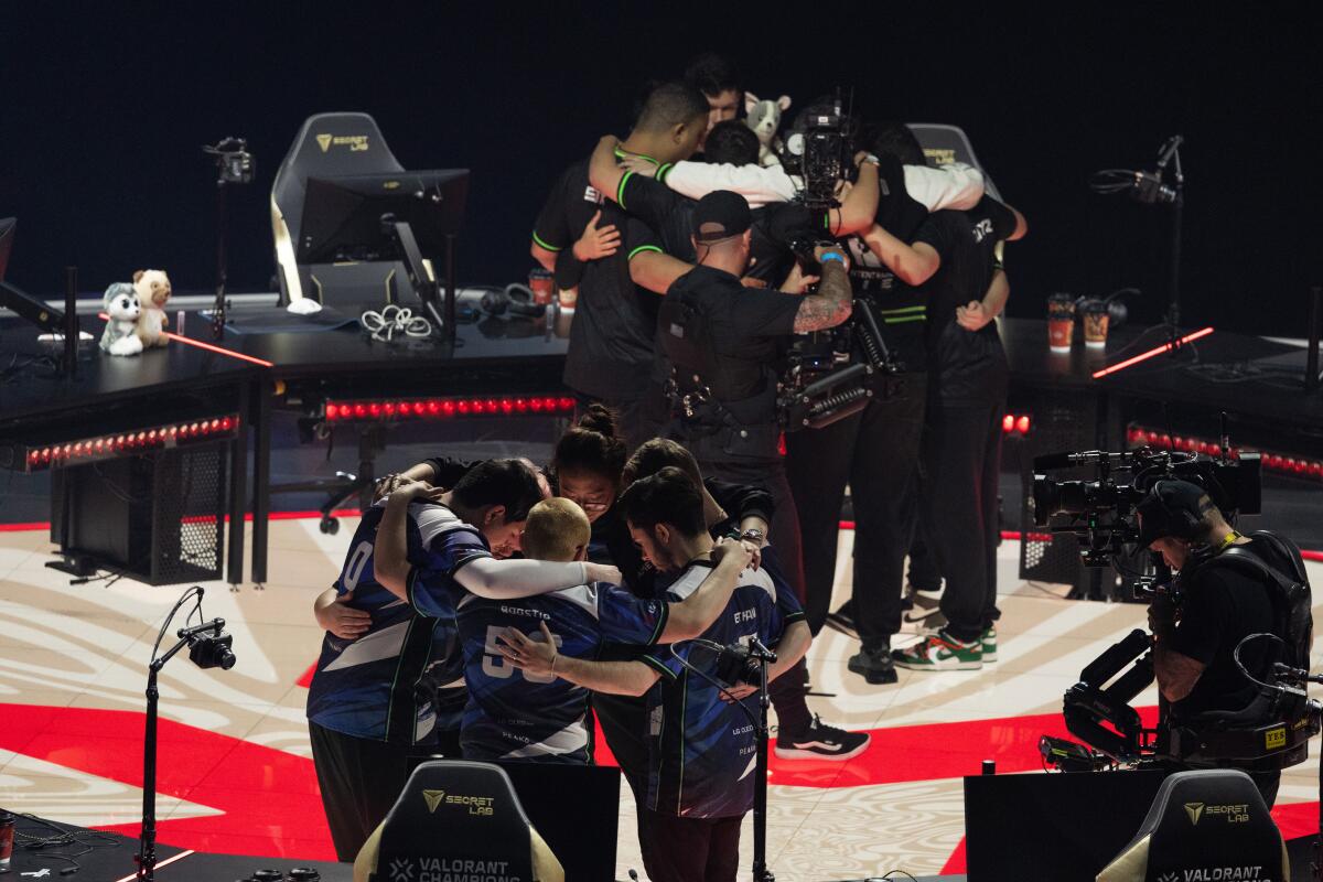 Players huddle before the start of their lower bracket final during the Valorant Champions Tournament