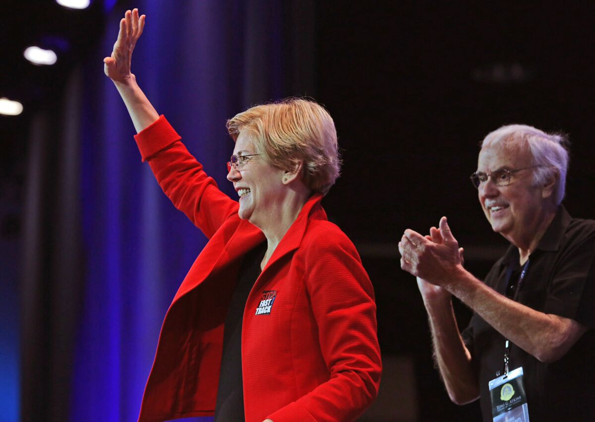 Massachusetts Sen. Elizabeth Warren takes the stage with party Chairnan John Burton at the California Democratic Party Convention on Saturday.