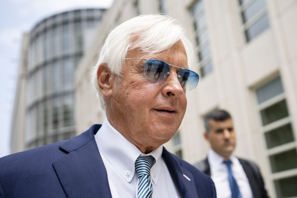 FILE - In this Monday July 12, 2021 file photo, horse trainer Bob Baffert leaves federal court in the Brooklyn borough of New York. A New York federal judge on Wednesday, July 14, 2021 nullified the suspension of horse trainer Bob Baffert, finding that the New York Racing Association acted unconstitutionally by failing to let him adequately respond to claims made against him after Kentucky Derby winner Medina Spirit failed a postrace drug test. (AP Photo/John Minchillo, File)